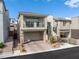 Attractive two-story home boasts a balcony, appealing landscaping, and a brick-paved driveway at 10806 Space Odyssey Ave, Las Vegas, NV 89129