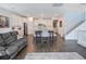 Spacious living area with an open layout connecting the kitchen, dining, and staircase at 10806 Space Odyssey Ave, Las Vegas, NV 89129