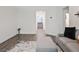 Open living room with gray sofa, ottoman, stylish rug, and bright decor, perfect for relaxation at 10806 Space Odyssey Ave, Las Vegas, NV 89129