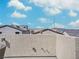 This image shows a rooftop deck bordered by a textured wall, featuring some other residences in the background at 10806 Space Odyssey Ave, Las Vegas, NV 89129
