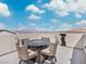 This home features a rooftop deck with a table and chairs and a distant mountain view at 10806 Space Odyssey Ave, Las Vegas, NV 89129