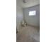 Bathroom in progress with new toilet installed and a plastic drop cloth on the floor at 116 Continental Ave, Henderson, NV 89015