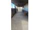 View of a long, concrete driveway, partially covered, and in need of maintenance at 116 Continental Ave, Henderson, NV 89015