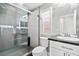 Modern bathroom with glass-enclosed shower, sleek fixtures, and sophisticated gray tiling at 133 S Buteo Woods Ln, Las Vegas, NV 89144