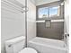 Bathroom featuring a bathtub with grey tile accents and a window at 133 S Buteo Woods Ln, Las Vegas, NV 89144