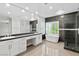Modern bathroom with double vanity, soaking tub, and glass-enclosed shower at 133 S Buteo Woods Ln, Las Vegas, NV 89144