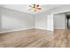 Bright bedroom features wood floors, ceiling fan, and natural light at 133 S Buteo Woods Ln, Las Vegas, NV 89144