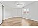 Bright bedroom features wood floors, ceiling fan, natural light, and closet at 133 S Buteo Woods Ln, Las Vegas, NV 89144