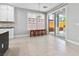 Bright dining area features tile flooring, ample sunlight, and sliding glass doors to the backyard at 133 S Buteo Woods Ln, Las Vegas, NV 89144