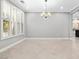 Elegant dining room with shuttered windows and a modern chandelier at 133 S Buteo Woods Ln, Las Vegas, NV 89144