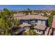 Stately two-story home featuring desert landscaping, a tile roof, and an attached three-car garage at 133 S Buteo Woods Ln, Las Vegas, NV 89144