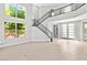 A stunning foyer with large windows, tile floors, a stairway and modern doors at 133 S Buteo Woods Ln, Las Vegas, NV 89144