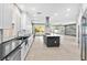Open concept kitchen features stainless steel appliances, center island, and backyard views at 133 S Buteo Woods Ln, Las Vegas, NV 89144