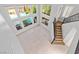 Open living area with lots of windows, a view of the pool and staircase at 133 S Buteo Woods Ln, Las Vegas, NV 89144