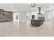 Spacious living room and kitchen area with large tiles and modern finishes for an open concept feel at 133 S Buteo Woods Ln, Las Vegas, NV 89144