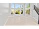 Bright living room with large windows providing natural light and views of the backyard at 133 S Buteo Woods Ln, Las Vegas, NV 89144