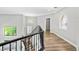 Bright staircase landing with modern chandelier and decorative wrought iron banister at 133 S Buteo Woods Ln, Las Vegas, NV 89144