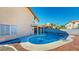 Inviting backyard featuring a sparkling pool, covered patio, and low-maintenance landscaping, perfect for outdoor relaxation at 1532 Ascension Cir, North Las Vegas, NV 89031