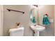 The half bathroom features a pedestal sink, toilet, and decorative mirror at 1532 Ascension Cir, North Las Vegas, NV 89031