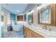 Bright bathroom featuring a freestanding tub, dual vanities with marble countertops, and decorative mirrors at 1532 Ascension Cir, North Las Vegas, NV 89031