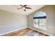 This bedroom features light gray walls, wood flooring, and a large arched window at 1532 Ascension Cir, North Las Vegas, NV 89031