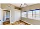 This bedroom features light gray walls, wood flooring, two windows, and a ceiling fan at 1532 Ascension Cir, North Las Vegas, NV 89031