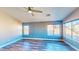 Spacious bedroom with wood floors, a ceiling fan, and large windows offering plenty of natural light at 1532 Ascension Cir, North Las Vegas, NV 89031