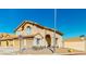 Tan two-story home with a two-car garage and desert landscaping at 1532 Ascension Cir, North Las Vegas, NV 89031