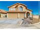 Inviting two-story home with a well-manicured yard, desert landscaping, and a two-car garage at 1532 Ascension Cir, North Las Vegas, NV 89031