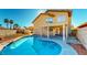 View of the swimming pool in the backyard with a covered patio and desert landscaping at 1532 Ascension Cir, North Las Vegas, NV 89031