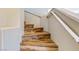Close-up of wooden staircase with white handrail and natural light at 1532 Ascension Cir, North Las Vegas, NV 89031