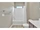 Clean bathroom with a white shower-tub combo, gray cabinets, and neutral-toned walls at 1536 Unison Way # 102, Las Vegas, NV 89135