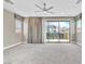 Bright bedroom with a ceiling fan, sliding door to balcony, and neutral carpet at 1536 Unison Way # 102, Las Vegas, NV 89135