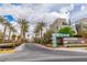 Entrance to Affinity community, lined with palm trees and landscaping, creating a welcoming atmosphere at 1536 Unison Way # 102, Las Vegas, NV 89135