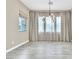 Dining area with elegant chandelier, light walls, and wide windows covered with decorative curtains at 1536 Unison Way # 102, Las Vegas, NV 89135