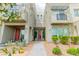 Contemporary townhouse featuring desert landscaping and a symmetrical facade with red doors at 1536 Unison Way # 102, Las Vegas, NV 89135