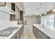 Stylish kitchen with stainless steel appliances, gray cabinets, a large island, and an open layout at 1536 Unison Way # 102, Las Vegas, NV 89135