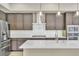 Modern kitchen featuring stainless steel appliances, gray cabinets and a center island with white countertops at 1536 Unison Way # 102, Las Vegas, NV 89135