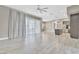 Expansive living area showcasing tile flooring, a modern ceiling fan, and an open concept kitchen at 1536 Unison Way # 102, Las Vegas, NV 89135