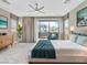 Comfortable main bedroom featuring a ceiling fan, sliding glass door to a balcony, and ample natural light at 1536 Unison Way # 102, Las Vegas, NV 89135