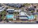 Modern community pool area with palm trees, lounge chairs, and multiple pools in a new development at 1536 Unison Way # 102, Las Vegas, NV 89135