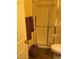 Bathroom with a shower, toilet, wood-look flooring, and towel rack at 1800 Edmond St # 213, Las Vegas, NV 89146
