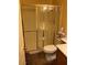 Bathroom showcasing a tiled shower with glass door, toilet, and vanity with countertop at 1800 Edmond St # 213, Las Vegas, NV 89146