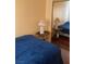 Bedroom features a single bed with a blue blanket, wood floors and a mirror at 1800 Edmond St # 213, Las Vegas, NV 89146