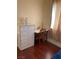 Bedroom features a desk, chest of drawers and wood floors at 1800 Edmond St # 213, Las Vegas, NV 89146
