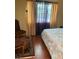 Bedroom with a window letting in natural light, showcasing a bed and classic-style chair at 1800 Edmond St # 213, Las Vegas, NV 89146