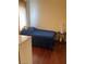 Bedroom features a single bed with a blue blanket and wood floors at 1800 Edmond St # 213, Las Vegas, NV 89146