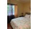 Bedroom featuring a bed with floral bedding and natural light filtering through sheer curtains at 1800 Edmond St # 213, Las Vegas, NV 89146
