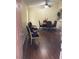 Inviting dining area featuring hardwood floors, stylish furniture, and a ceiling fan for comfortable living at 1800 Edmond St # 213, Las Vegas, NV 89146
