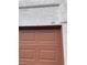 Close-up of the garage door with unit number 213, highlighting the neutral color and paneled design at 1800 Edmond St # 213, Las Vegas, NV 89146